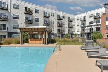 a swimming pool in front of an apartment building